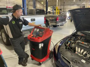 mechanic doing AC refrigerant system service